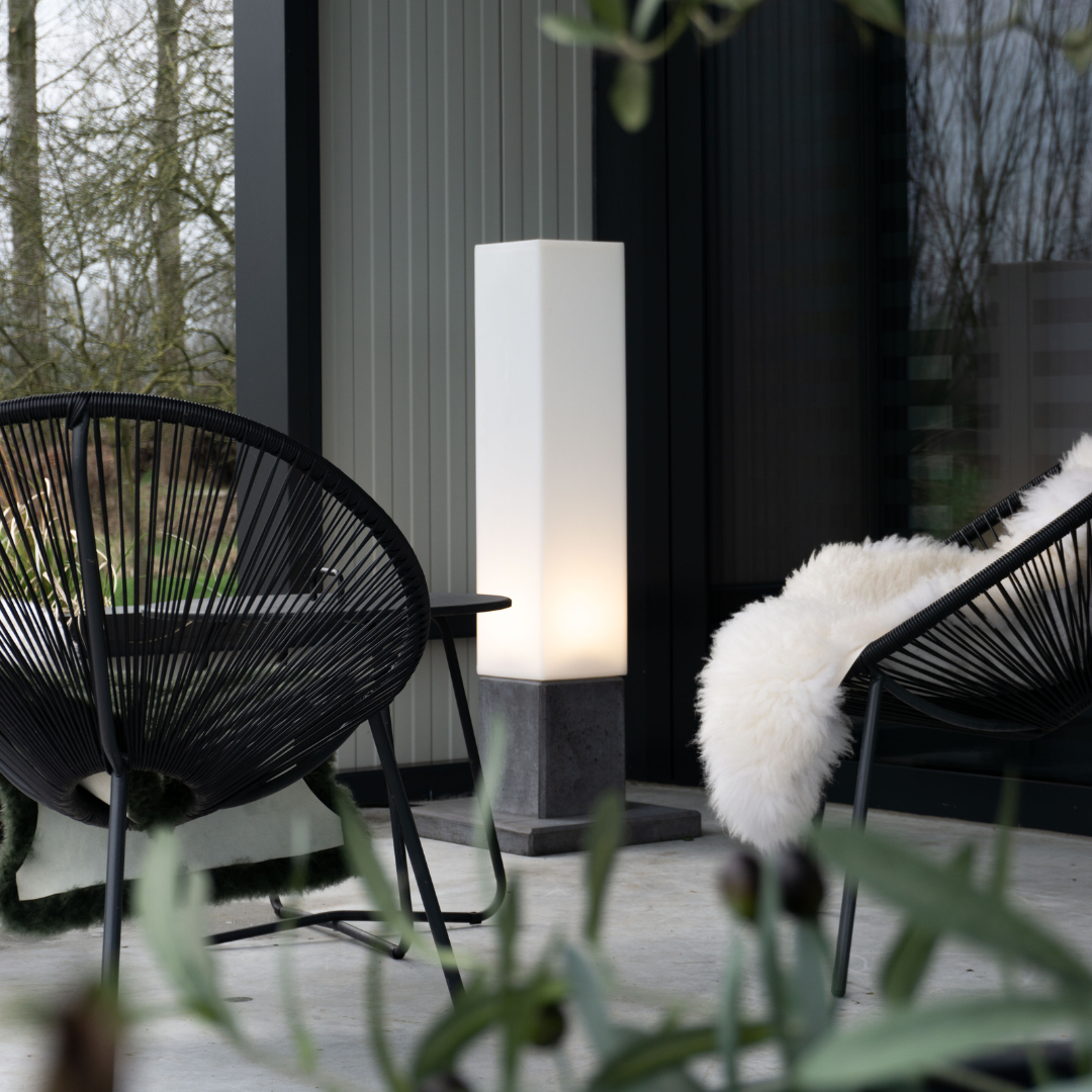 Linea high buitenlamp design van Dislux, moderne buitenlamp op terras tussen zwarte stoelen