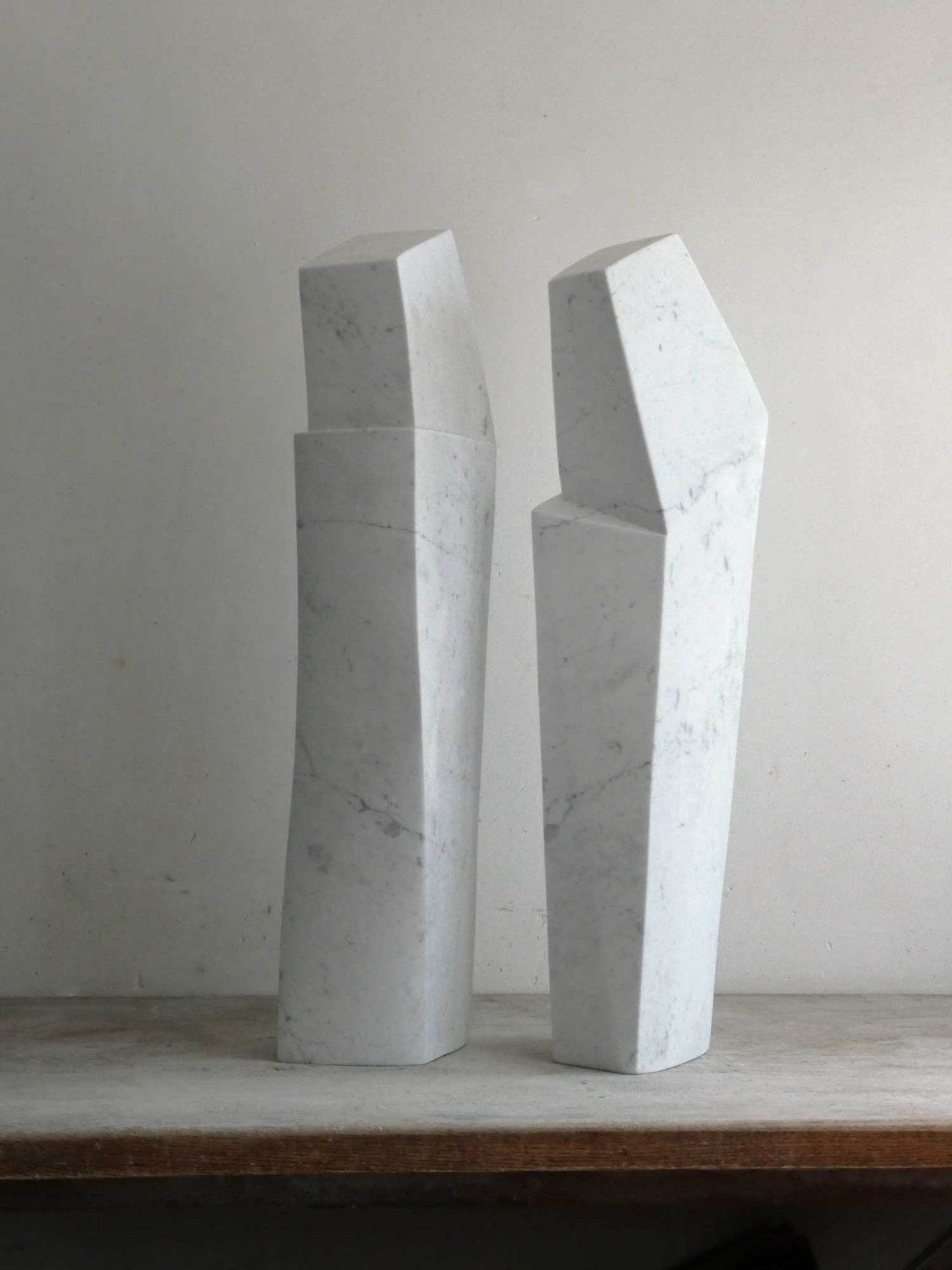 Twee moderne marmeren beelden voor interieur van Fieke de Roij met unieke geometrische vormen.